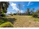 Expansive grassy backyard with a glimpse of waterfront views at 11465 7Th E St, Treasure Island, FL 33706