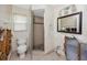 Damaged bathroom featuring a shower stall with tiled walls and a toilet next to a window at 11465 7Th E St, Treasure Island, FL 33706