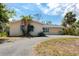 A charming single-story home with mature landscaping and a side entry garage at 11465 7Th E St, Treasure Island, FL 33706