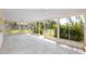 Bright Florida room with tile flooring, and numerous glass panels offering natural lighting and outdoor views at 11465 7Th E St, Treasure Island, FL 33706