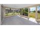 Bright sunroom with large windows overlooking the backyard, offering serene outdoor views and natural light at 11465 7Th E St, Treasure Island, FL 33706