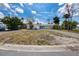 Single-story home featuring a circular driveway and a well-maintained front yard at 11465 7Th E St, Treasure Island, FL 33706