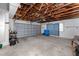 Spacious garage with a garage door and exposed wooden ceiling beams and ample space at 11465 7Th E St, Treasure Island, FL 33706