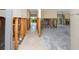Interior view showcasing an open-concept layout with exposed studs, tile flooring, and partially renovated walls at 11465 7Th E St, Treasure Island, FL 33706