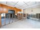 Kitchen featuring oak cabinets, a microwave, unfinished walls, and a tiled floor at 11465 7Th E St, Treasure Island, FL 33706