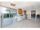 Open kitchen featuring oak cabinets, access to the sunroom, and unfinished walls at 11465 7Th E St, Treasure Island, FL 33706