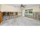Room featuring a ceiling fan, multiple windows providing natural light, and partially exposed concrete block and wall structure at 11465 7Th E St, Treasure Island, FL 33706