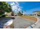 Well-maintained single-story home with lush greenery along the entrance and street at 11465 7Th E St, Treasure Island, FL 33706
