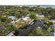 Waterfront property with expansive backyard, dock, canal access and lush tropical landscaping at 12 Bayou Ln, Palm Harbor, FL 34683