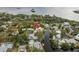 An aerial view of a charming waterfront property with a private dock, and lush trees at 12 Bayou Ln, Palm Harbor, FL 34683