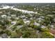Expansive aerial view of a waterfront community with lush greenery and serene waterways and single Gathering homes at 12 Bayou Ln, Palm Harbor, FL 34683