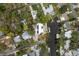 Overhead view of home featuring water access, solar panels, mature trees, and surrounding neighborhood at 12 Bayou Ln, Palm Harbor, FL 34683