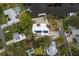 Property with canal access with a dock, solar panels, backyard fire pit and tropical landscaping at 12 Bayou Ln, Palm Harbor, FL 34683