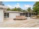 Wood deck features a built in bench, outdoor space and access to screened-in lanai at 12 Bayou Ln, Palm Harbor, FL 34683