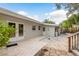Backyard patio with stone pavers, double doors, and privacy landscaping, perfect for outdoor entertaining at 12 Bayou Ln, Palm Harbor, FL 34683