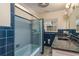 Bright bathroom featuring tiled walls, glass enclosed shower, and granite topped double sink vanity at 12 Bayou Ln, Palm Harbor, FL 34683
