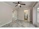 Bedroom featuring tile floors, neutral paint, ceiling fan, and a view into an attached bathroom at 12 Bayou Ln, Palm Harbor, FL 34683