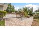 Beautiful wooden deck and brick patio with mature tropical landscaping at 12 Bayou Ln, Palm Harbor, FL 34683