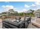 Outdoor deck featuring stylish patio furniture, an umbrella-covered table, and a beautiful water view at 12 Bayou Ln, Palm Harbor, FL 34683