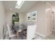 Bright dining room with a modern table set, decorative plants and skylight at 12 Bayou Ln, Palm Harbor, FL 34683