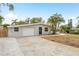 Beautiful home featuring a well-kept lawn, driveway, and quaint single-story facade at 12 Bayou Ln, Palm Harbor, FL 34683