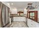 Bright kitchen with white cabinets, granite countertops, stainless steel appliances, and decorative tile flooring at 12 Bayou Ln, Palm Harbor, FL 34683