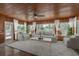 Cozy sunroom with wood paneling, multiple windows, and comfortable seating arrangements at 12 Bayou Ln, Palm Harbor, FL 34683