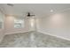 Inviting living room with sleek tile flooring, bright windows, and a welcoming front entrance at 12 Bayou Ln, Palm Harbor, FL 34683