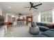 Open-concept living area showcasing tile flooring, seamless transition to the kitchen, and a blue sofa at 12 Bayou Ln, Palm Harbor, FL 34683