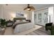 Cozy bedroom features neutral tones, a ceiling fan, and private access to the backyard at 12 Bayou Ln, Palm Harbor, FL 34683