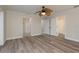 Spacious bedroom with wood floors, a ceiling fan, and access to a walk-in closet at 12 Bayou Ln, Palm Harbor, FL 34683