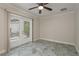 Bright room with tile floors, neutral paint, ceiling fan, and double glass doors leading to outside at 12 Bayou Ln, Palm Harbor, FL 34683