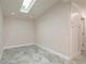 Bright room with a skylight, neutral walls, tiled floors, and built-in cabinets at 12 Bayou Ln, Palm Harbor, FL 34683