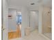 Bright hallway leading to bathroom with glass shower and hardwood flooring in adjacent bedroom at 1200 Gulf Blvd # 1704, Clearwater Beach, FL 33767
