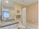Bathroom featuring granite countertops, framed mirror, and bathtub with shower at 1200 Gulf Blvd # 1704, Clearwater Beach, FL 33767