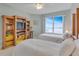 Light and airy bedroom featuring two twin beds and a wall of custom built-in bookshelves at 1200 Gulf Blvd # 1704, Clearwater Beach, FL 33767