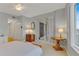 Bright bedroom with a ceiling fan, a table, and a sliding glass door leading to a balcony at 1200 Gulf Blvd # 1704, Clearwater Beach, FL 33767