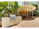Outdoor grilling area under a covered gazebo with stainless steel grill, cabinets, and seating for community entertaining at 1200 Gulf Blvd # 1704, Clearwater Beach, FL 33767