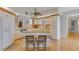 A view of the kitchen featuring white cabinets, granite countertops, and hardwood flooring at 1200 Gulf Blvd # 1704, Clearwater Beach, FL 33767