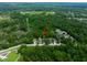 Home is shown from an aerial view surrounded by lush trees and other houses at 12208 Mcmullen Loop, Riverview, FL 33569