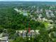 Aerial view of a home surrounded by lush green trees and a lake nearby at 12208 Mcmullen Loop, Riverview, FL 33569
