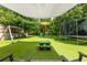Amazing backyard with a swing set, slide, trampoline, picnic table, and shade, perfect for outdoor fun at 12208 Mcmullen Loop, Riverview, FL 33569