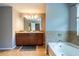 Bathroom featuring double sinks, a shower, and a soaking tub at 12208 Mcmullen Loop, Riverview, FL 33569