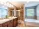 Primary bathroom featuring double sinks, a shower and a separate soaking tub at 12208 Mcmullen Loop, Riverview, FL 33569