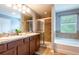 Bathroom featuring double sinks, a shower and a separate soaking tub at 12208 Mcmullen Loop, Riverview, FL 33569