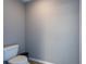 Bathroom featuring a toilet, grey walls, and tan tile at 12208 Mcmullen Loop, Riverview, FL 33569