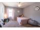 Cozy bedroom featuring a plush bed, soft carpet, and a ceiling fan for added comfort at 12208 Mcmullen Loop, Riverview, FL 33569