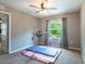 Neutral bedroom featuring a gymnastics bar with soft mats and window offering natural light at 12208 Mcmullen Loop, Riverview, FL 33569