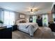 Spacious bedroom featuring a king bed, ceiling fan, and windows providing natural light at 12208 Mcmullen Loop, Riverview, FL 33569