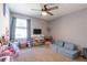 Childs bedroom featuring a window, sofa, tv, toys and neutral paint at 12208 Mcmullen Loop, Riverview, FL 33569